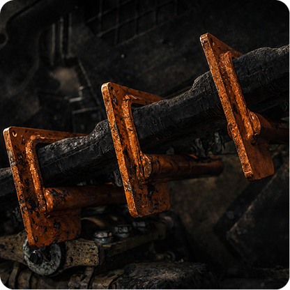 Rusty orange mining cart wheels on dark metal rails in an underground tunnel or cave setting