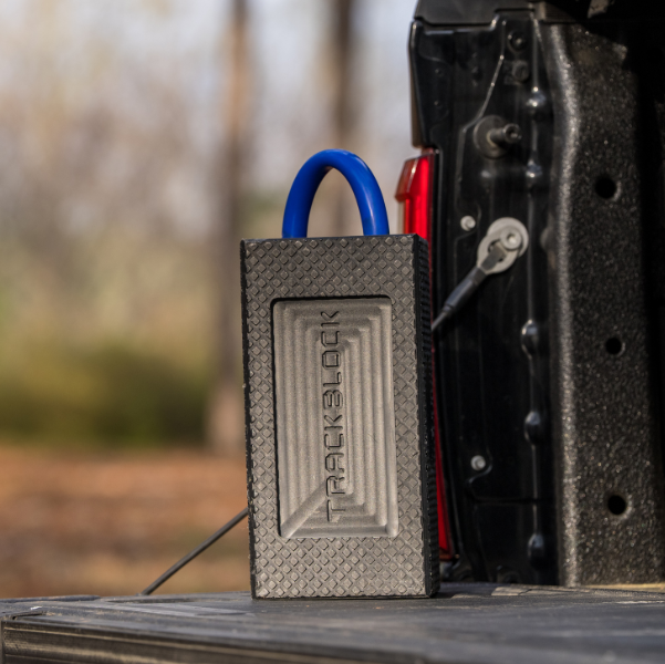 TrackBlock security device with blue carabiner on truck bed tailgate